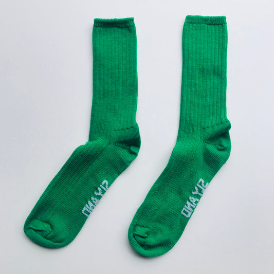 Pair of green socks with text on a light gray background